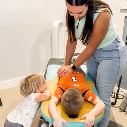 Chiropractor providing gentle care to child at Foundation Family Chiropractic